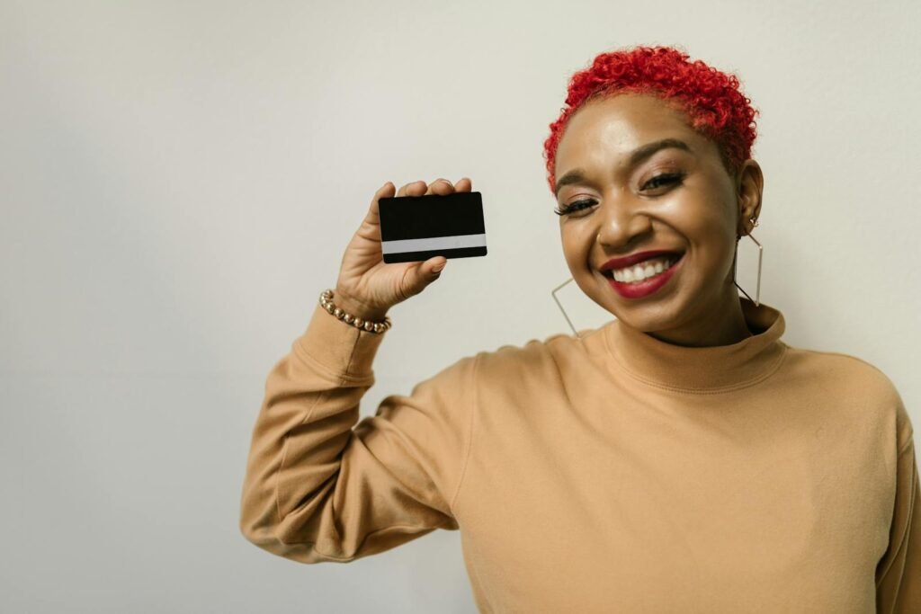 Woman in Brown Sweater Holding a Credit Card